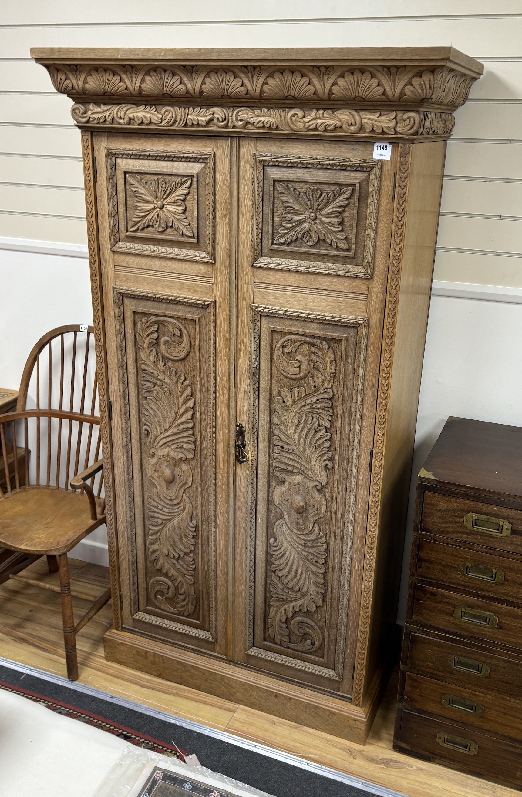 A late Victorian carved bleached oak wardrobe, width 103cm, depth 53cm, height 191cm